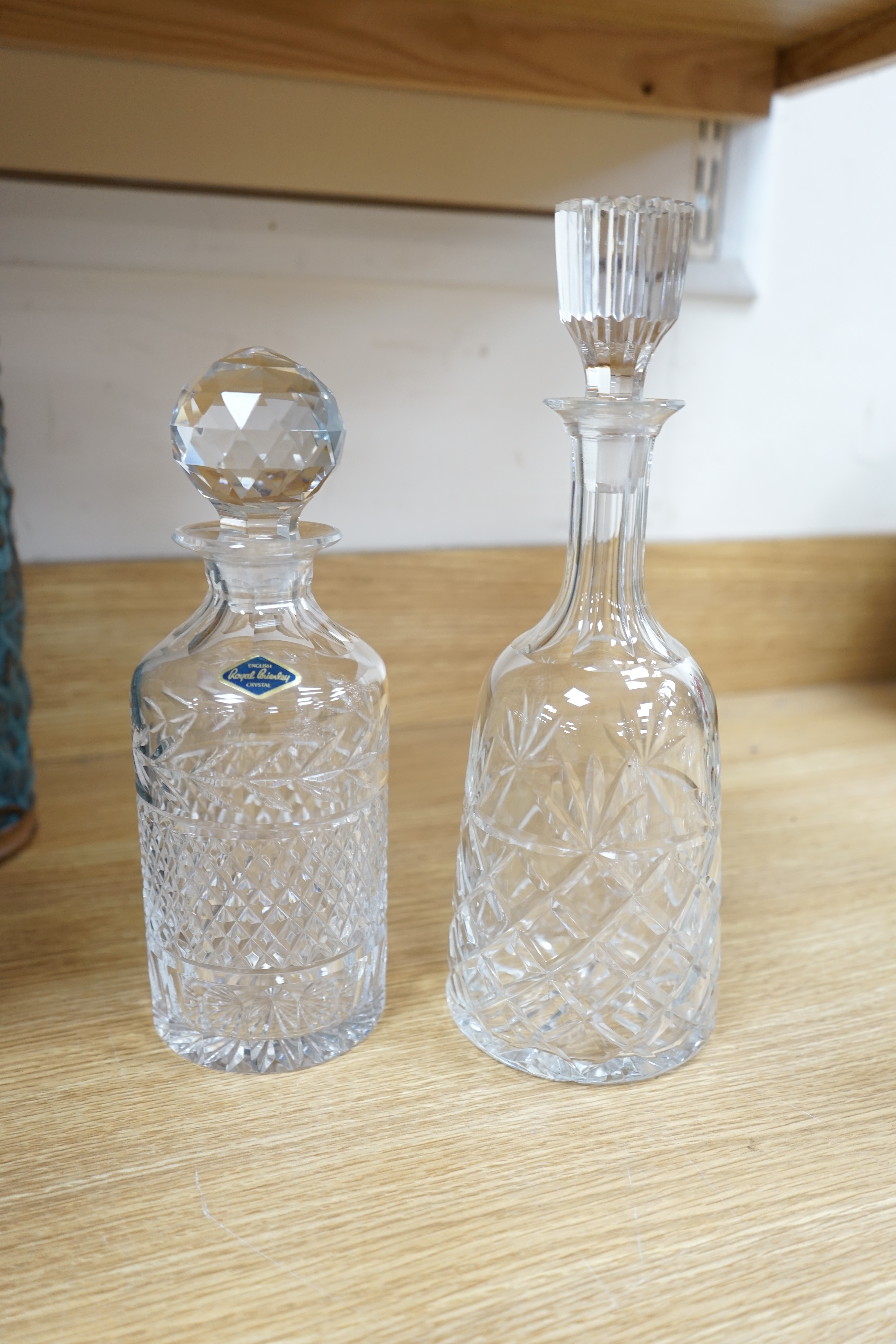 A cut glass ship’s decanter, two others and three various cut glass candle sticks, tallest decanter 30cm high. Condition - good